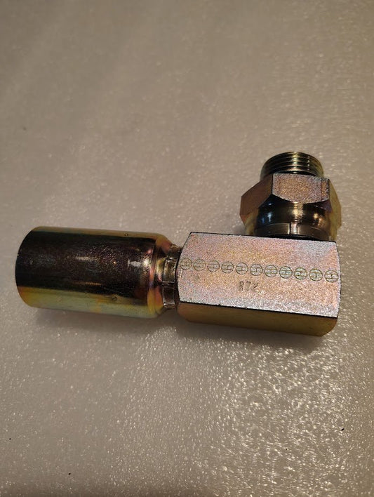 A 12U-R72 Weatherhead 3/4 Hose x 3/4 ORB Male Fitting - 90 Elbow Swivel rests on a metallic-textured surface. It features engraved markings, indicating seamless connectivity with 100R2 hoses.