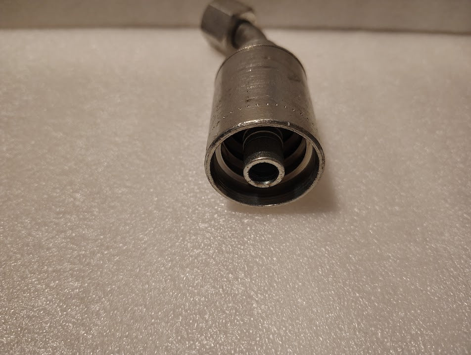A close-up of a metallic 43008U-688 Weatherhead 1/2 Hose x 1/2 JIC Female Fitting (GW25-8x8), showing the threaded opening and inner components on a textured white surface—ideal for compatible hydraulic hoses.