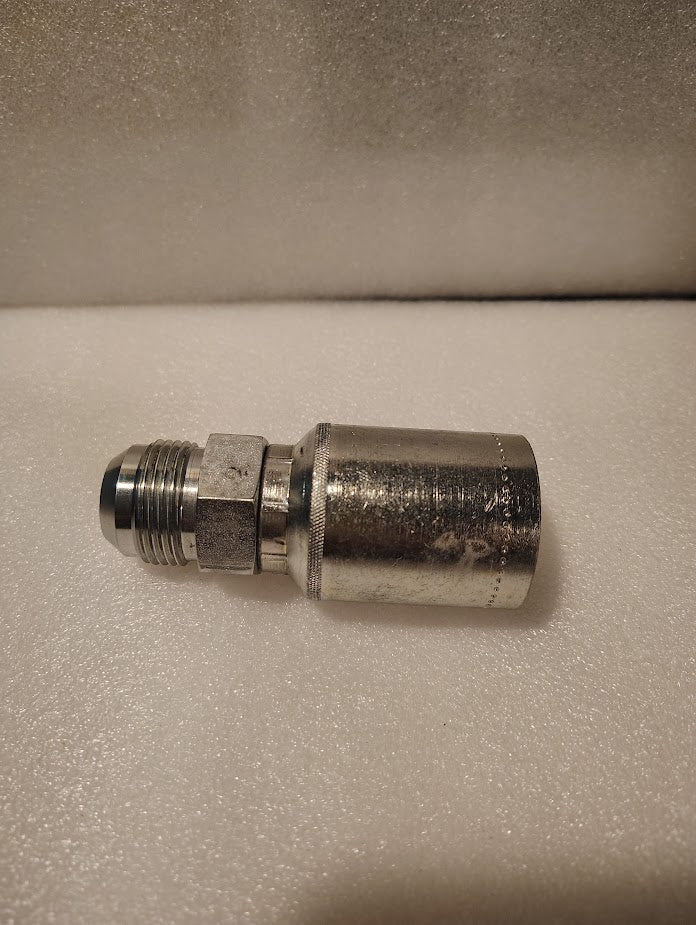 A 43012U-514 | 3/4 Hose x 7/8 JIC Solid Fitting - Straight (GW08-12x14) with a hexagonal nut and threaded connector is positioned horizontally on a white, textured surface.