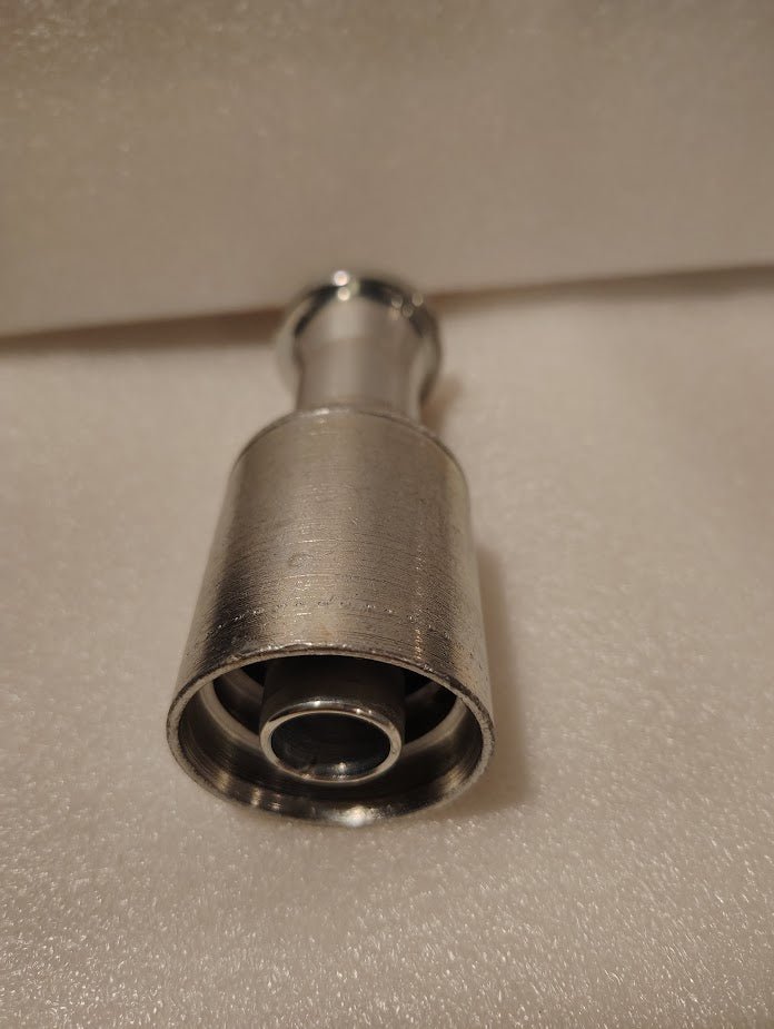 A close-up photo of a Weatherhead 43012U-G12 3/4 Hose x 3/4 Code 61 Flange Fitting (GW47-12x12) shown on a soft, light-colored surface with a blurred background.