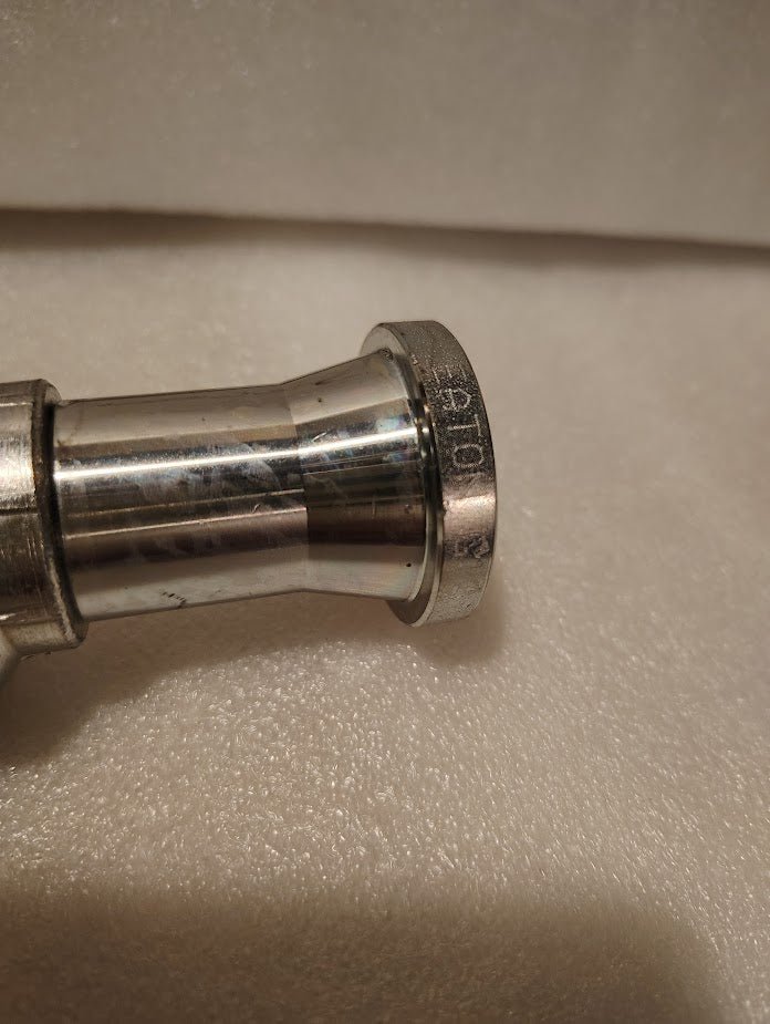 Close-up of a shiny Weatherhead 43012U-G12 3/4 Hose x 3/4 Code 61 Flange Fitting (GW47-12x12), placed on a soft, light-colored surface with engraved text and numbers visible on the rim.