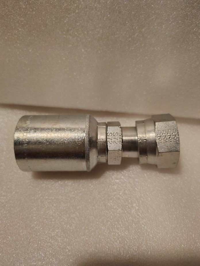 A close-up of a Weatherhead 43012U-S72 GW30-12x12 fitting (3/4 hose x 3/4 ORFS female) with threaded ends and engraved hex, shown on a textured white surface.