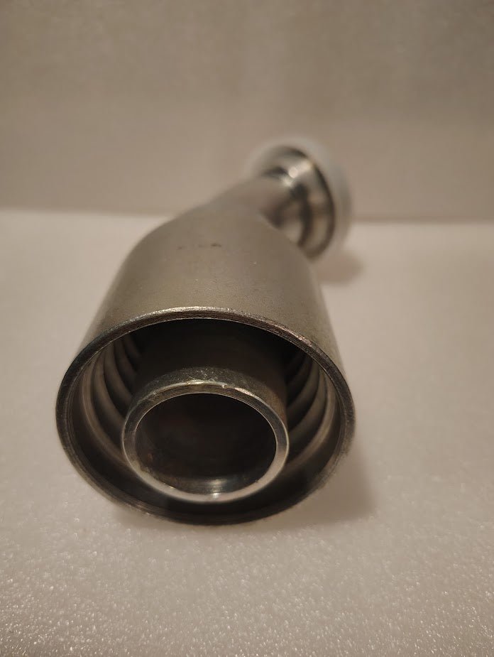 Close-up view of the 43024U-G54 | 1 1/2 Hose x 1 1/2 Code 61 Flange Fitting—showing its precision-engineered, metallic components and distinctive bend—set against a plain, light-colored background.