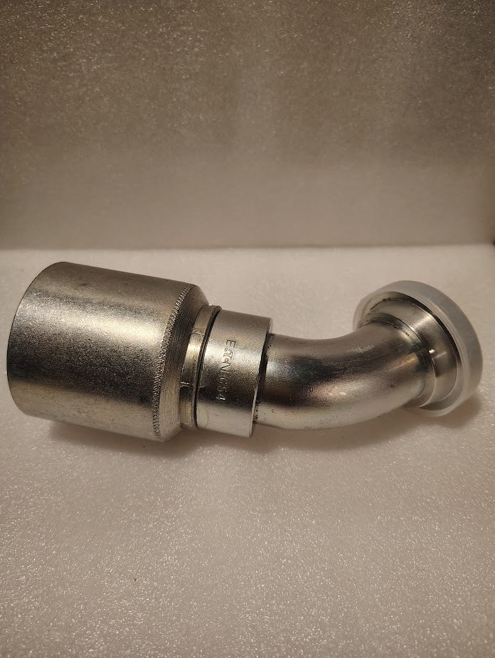 A 1 1/2 hose x 1 1/2 Code 61 flange fitting with a 45-degree bend (43024U-G54 | GW50-24x24) rests on a textured white surface—perfect for applications needing this specific Weatherhead hydraulic fitting.