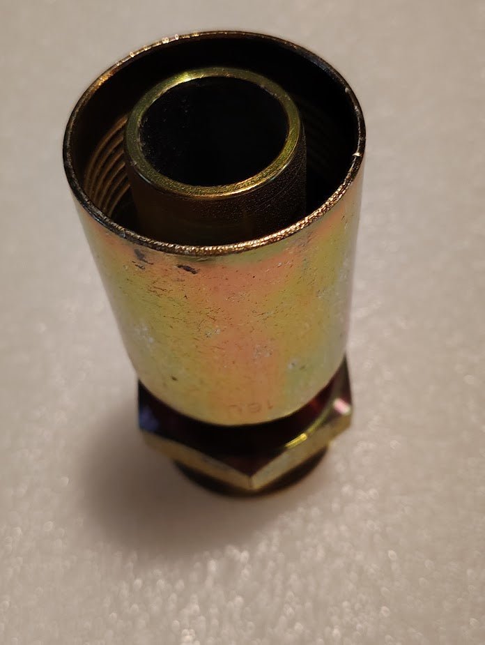 Close-up of a 16U-520 Weatherhead male pipe fitting, featuring threaded ends for 1 Hose x 1 1/4 JIC compatibility, a cylindrical shape with a hexagonal base, set against a textured white background.