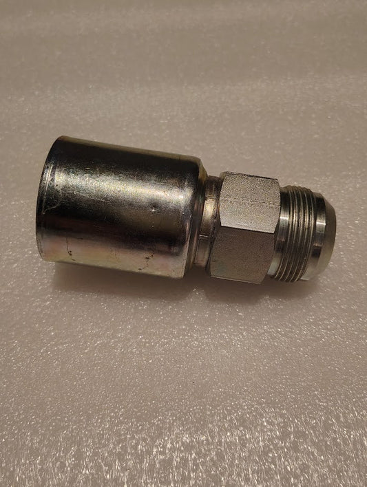 A cylindrical metallic item with threads and a hexagonal section is on a textured surface, resembling a Weatherhead 20U-520 Hose x JIC Male Fitting, suggesting its a pipe connector or coupling component.