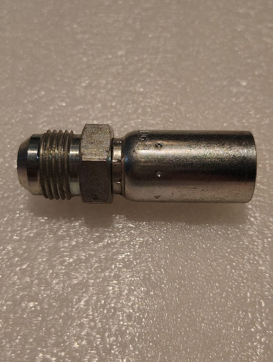 The 06U-510 Weatherhead fitting, a 3/8 hose x 5/8 JIC male fitting with threaded ends and hexagonal nut, connects seamlessly to a cylindrical body. Its precision and robustness evoke the reliable quality of hydraulic hose fittings against a textured, off-white surface.
