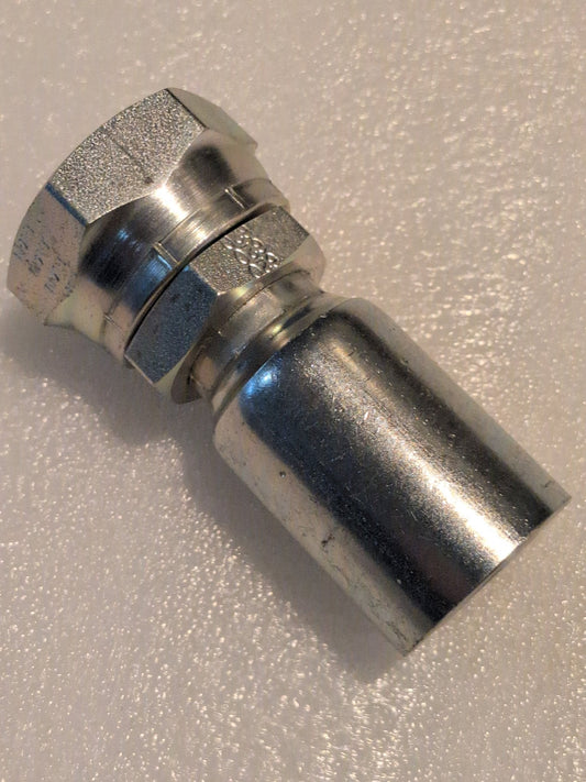 A close-up of a metallic coaxial connector, with precision akin to the 16U-620 Weatherhead fitting, featuring a hexagonal nut and smooth cylindrical body on a white surface, perfect for connecting coaxial cables to devices.
