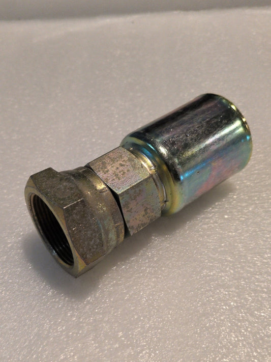 A 20U-620 Weatherhead fitting, with a 1 1/4 hose x JIC female threaded connector and a smooth cylindrical body, elegantly rests on a light gray surface, reflecting the precision characteristic of Weatherhead products.