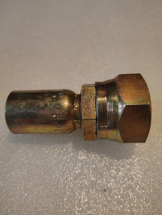 A Weatherhead 08U-616 fitting lies on a light background. Its hexagonal nut and cylindrical section show tarnished reflections. Paired with compatible hoses, it rests against a softly textured surface, highlighting its engineered precision.