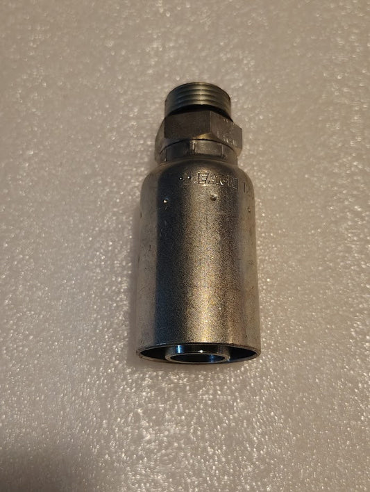 A 12U-P10 Weatherhead 3/4 Hose x 5/8 ORB Male Fitting with a threaded end lies on a textured white surface. The unused nozzles cylindrical shape and shiny metal finish mimic hydraulic hose fittings.