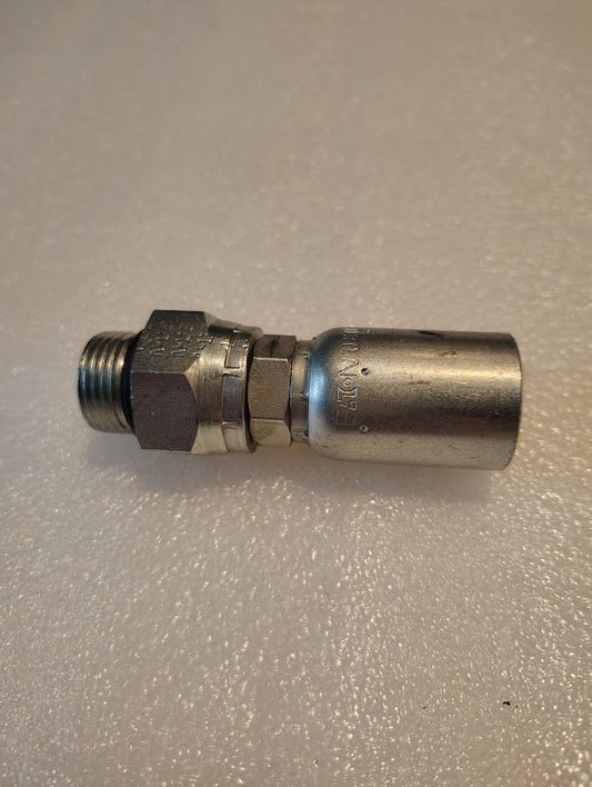 A metallic Weatherhead 08U-R10 hydraulic fitting with a threaded end and hexagonal nut rests on a textured white surface, showcasing precision engineering for integration with any hose system.