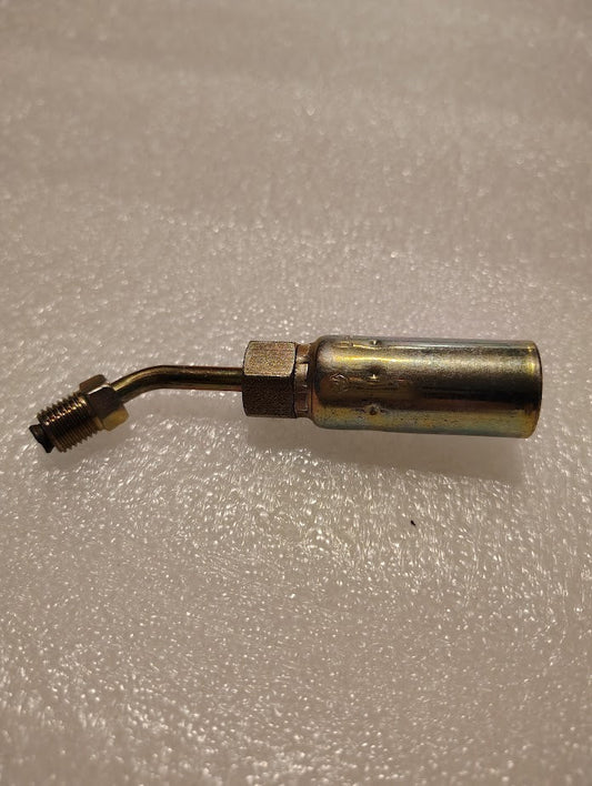 A Weatherhead 04U-B43 metal valve with a cylindrical body and a bent nozzle rests on a textured white surface. The threaded end supports 100R1 compatible fittings, ideal for hydraulic hose connections, and its metallic sheen suggests its made from brass or similar material.