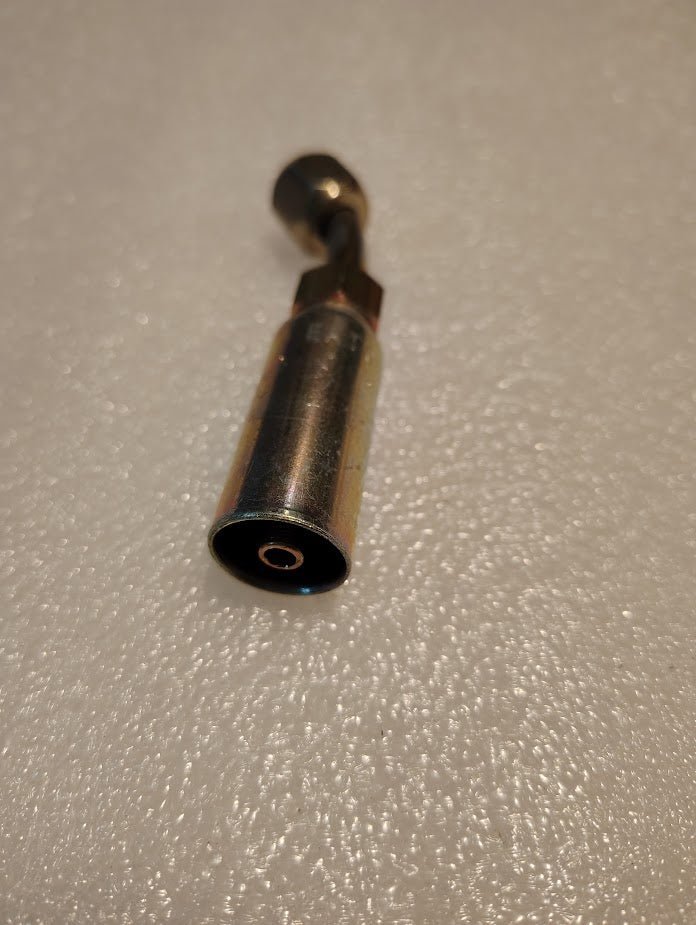 Close-up of a metal socket wrench with a cylindrical extension, similar to the Weatherhead 1/4 Hose x 5/16 JIC/SAE Female Fitting - 45 Swivel (04U-685), placed on a textured white surface.