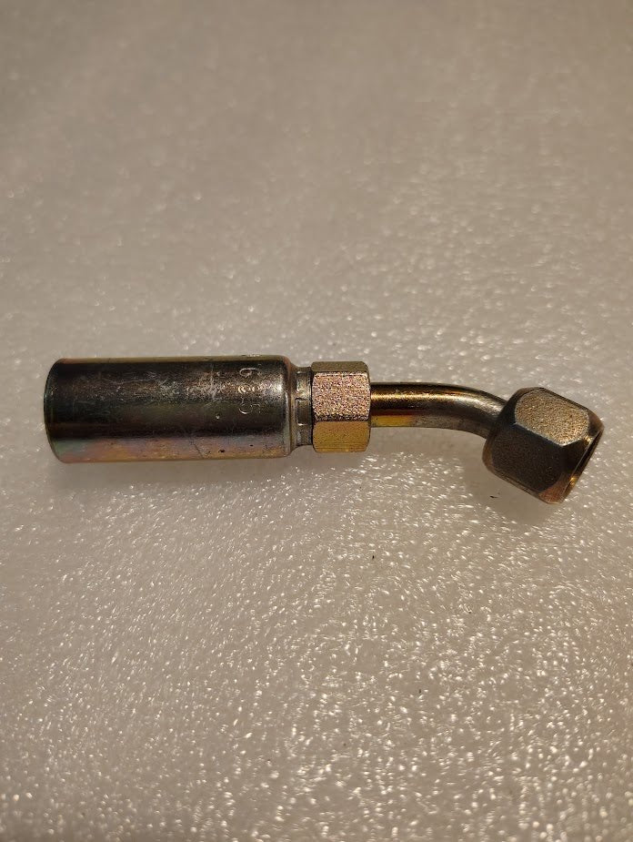 The 04U-685 Weatherhead 1/4 Hose x 5/16 JIC/SAE Female Fitting - 45 Swivel has a right-angled bend, hexagonal nut connector, and a shiny textured surface that stands out against the rough background.