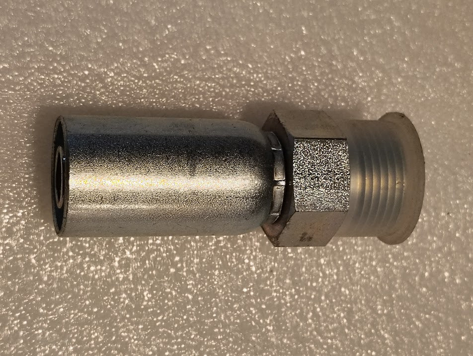 The 10U-E72 Weatherhead 5/8 Hose x 3/4 ORF Male Fitting is a straight solid metal fitting with a hexagonal nut section, compatible with 100R1, featuring threaded ends and a smooth cylindrical body lying flat on a textured white surface.
