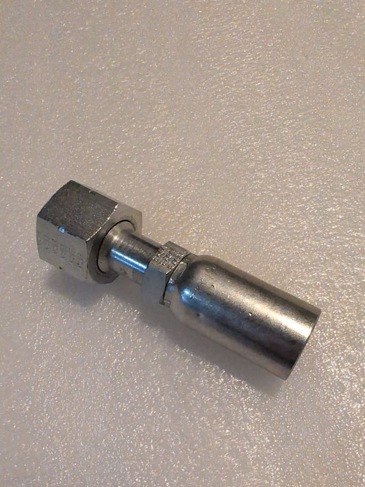 Close-up of a metal mechanical fitting, 10U-S72, featuring a hexagonal bolt and cylindrical connector, compatible with Weatherhead fittings; 5/8 Hose x 3/4 ORF Female Fitting - Straight Swivel, resting on a textured light-colored surface.