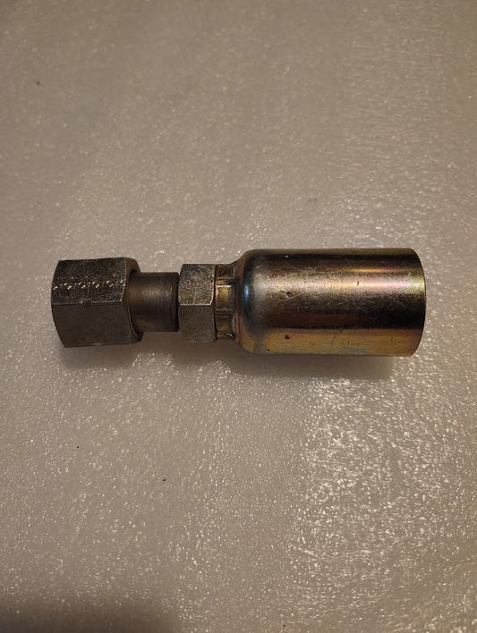 The Weatherhead 12U-S70 model is a straight swivel fitting for a 3/4 hose with a 5/8 ORF female connection, featuring a hexagonal nut and cylindrical component, resting elegantly on a textured light surface.