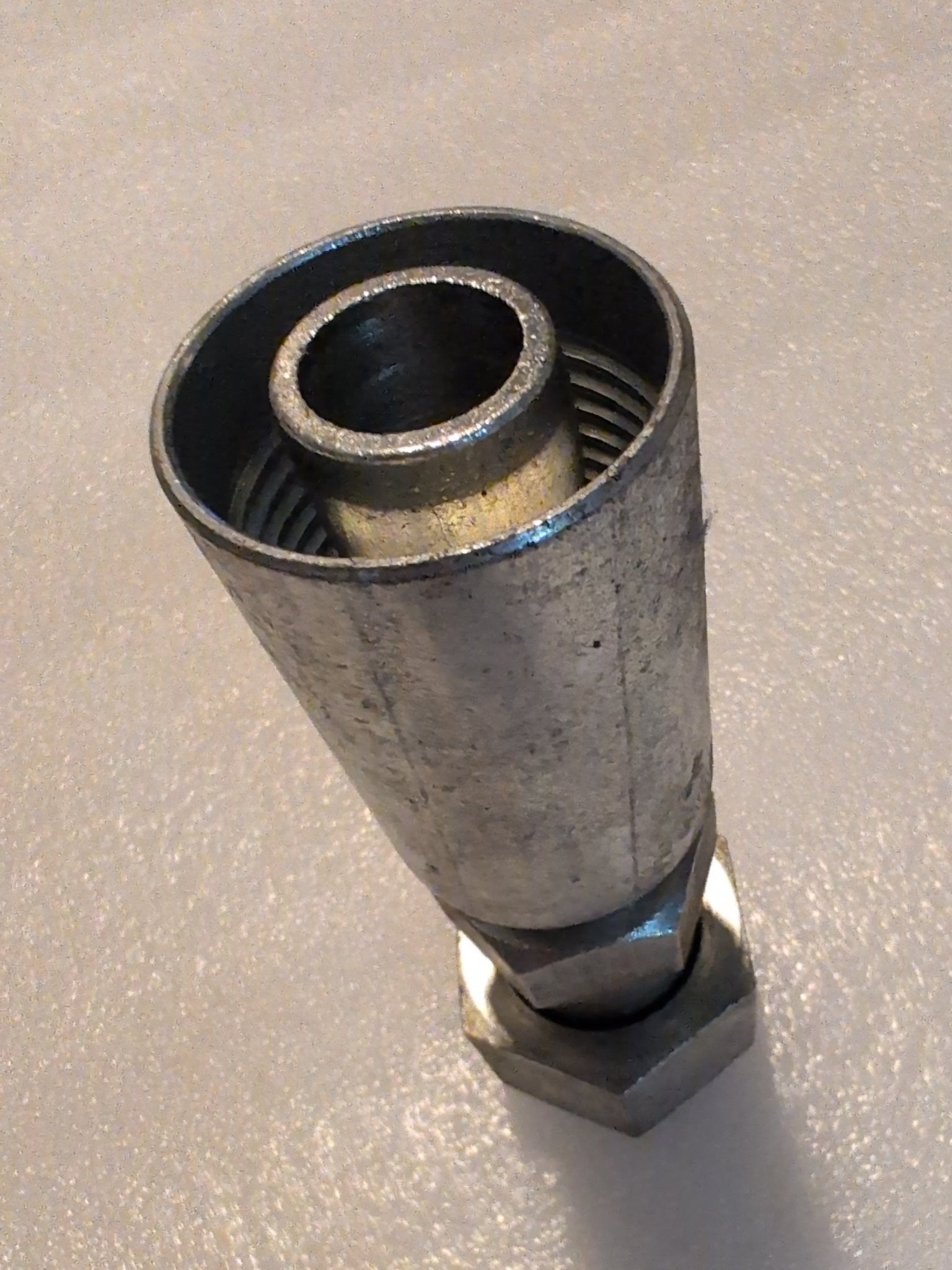The Weatherhead 12U-S76 straight swivel fitting with a 3/4 hose x 1 ORF female connection stands upright, showcasing its robust utility for plumbing or industrial use. Its metallic surface has a slightly tarnished appearance, highlighting its function in hydraulic systems.