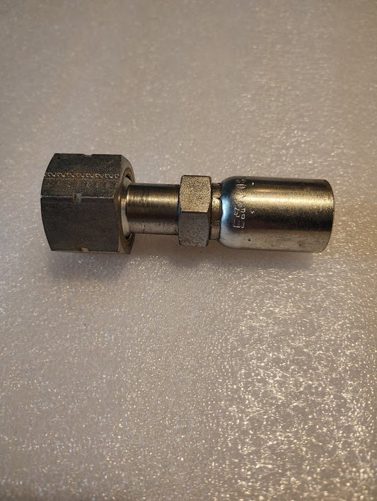 The 08U-S72 Weatherhead fitting, a metal hydraulic piece compatible with 100R1, sits on a textured surface. With features like a hexagonal nut and cylindrical connector, it showcases the durability and precision of Weatherhead fittings in sleek metallic tones.