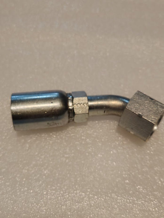 The 08U-L70 Weatherhead 1/2 Hose x 5/8 ORF Female Fitting, featuring a metallic elbow joint with a nut and shiny finish, rests on a textured white surface. Its compatibility with 100R1 hydraulic hose fittings makes it ideal for plumbing or mechanical applications.
