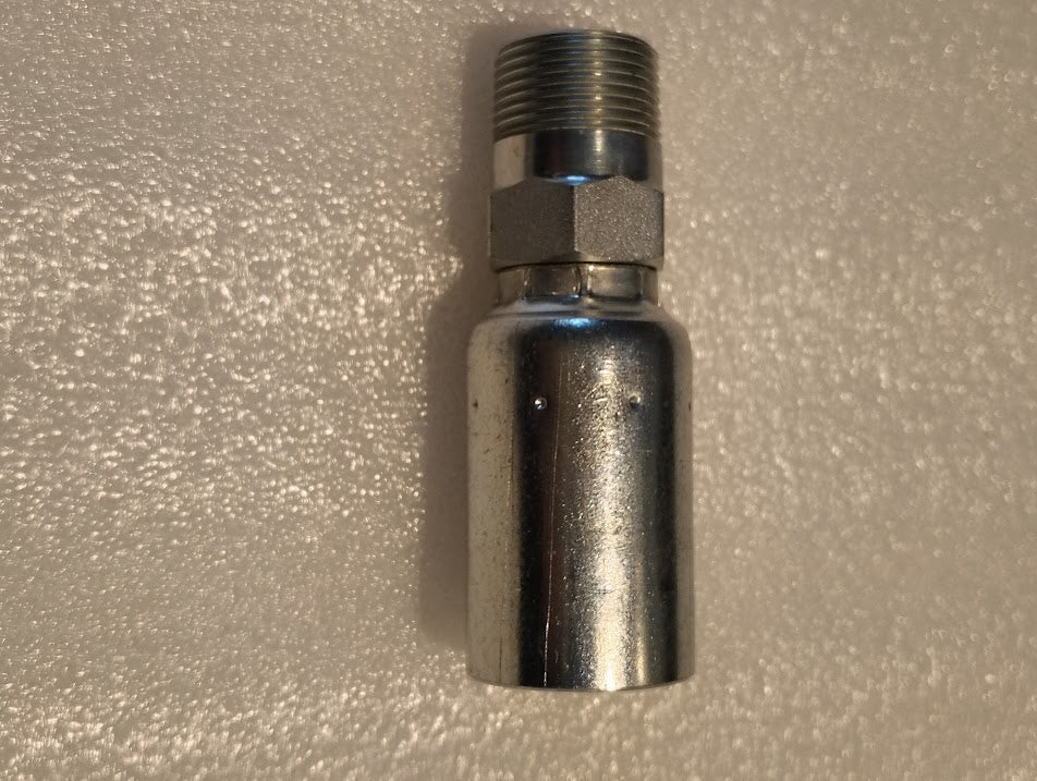 A Weatherhead 12U-162 fitting, with a sturdy straight solid design and dimensions of 3/4 hose x 3/4 BSPT male, rests on a textured white surface. This shiny piece is perfect for plumbing or machinery connections.