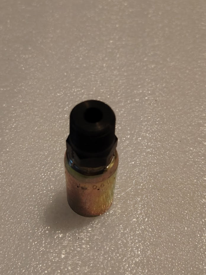 A metallic cylindrical 06U-156 Weatherhead fitting with a black top stands upright on a textured white surface, featuring engraved markings that suggest its precision-engineered use in hydraulic hoses.
