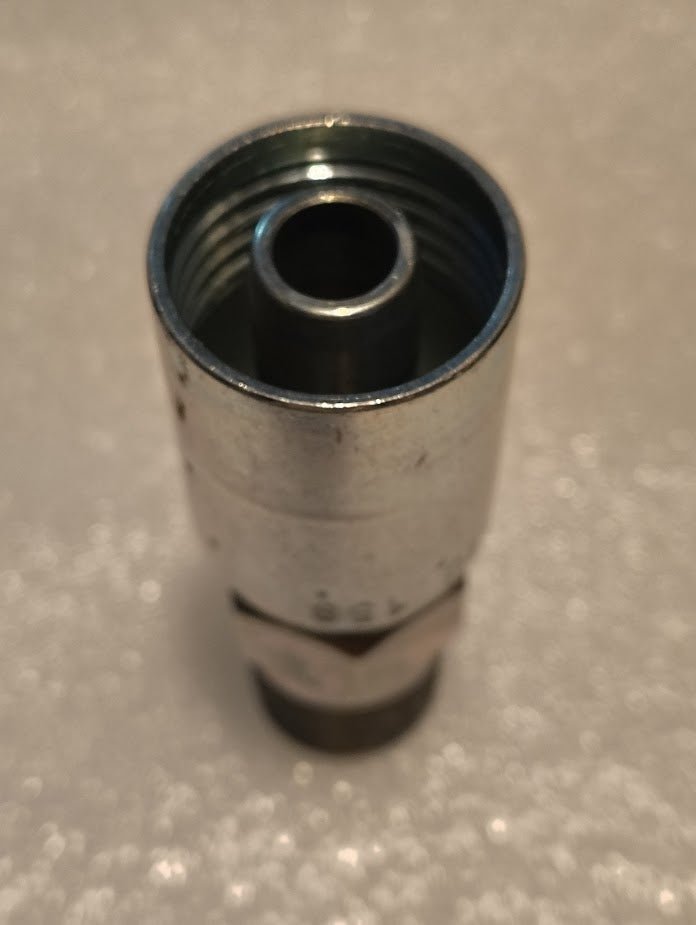 A metallic cylindrical object, identified as a Weatherhead 08U-158 fitting, is shown against a soft-focus background. It features a threaded interior and shiny exterior, suitable for use with 1/2 hoses and hydraulic hose fittings.