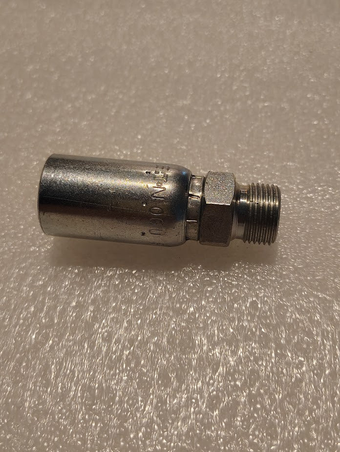 A Weatherhead 3/8 Hose x 3/8 BSPT Male Fitting - Straight Solid (06U-P56), featuring a cylindrical body and threaded end, rests on a textured white surface.