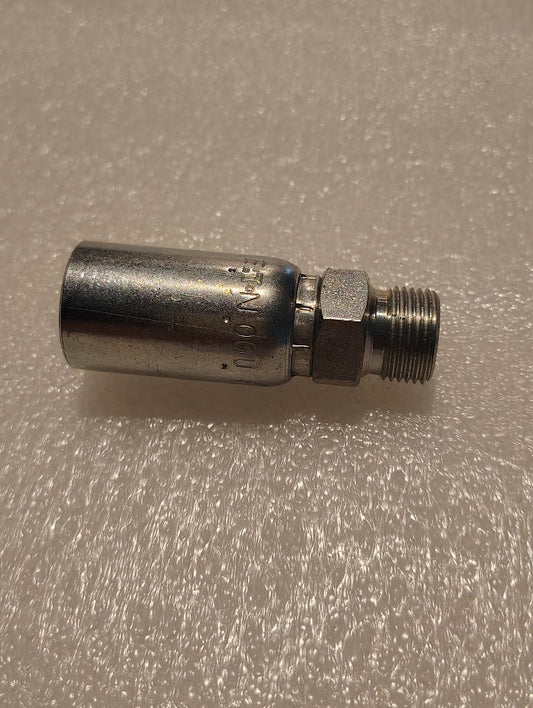 A Weatherhead 3/8 Hose x 3/8 BSPT Male Fitting - Straight Solid (06U-P56), featuring a cylindrical body and threaded end, rests on a textured white surface.
