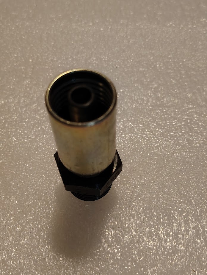 A close-up of the 06U-P58 Weatherhead fitting, featuring a brass-colored exterior and a black base, is upright against a textured, light-colored background.