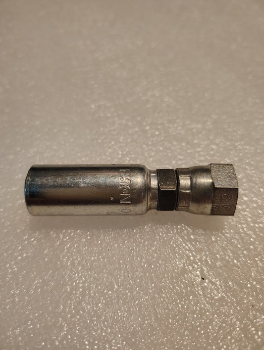 The 04U-06C Weatherhead 1/4 Hose x M12x1.5 DIN Female Fitting - Straight Swivel rests on a textured light surface, featuring a cylindrical shape that complements its hexagonal nut, ensuring seamless pairing with compatible hoses.