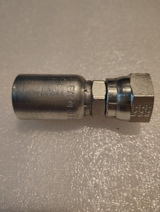 The 08U-15C Weatherhead fitting, a metallic hydraulic hose connector with hex ends and cylindrical body, shines on a textured backdrop. Its precision design ensures compatibility with 100R1 applications and showcases the excellence of Weatherhead fittings in versatile uses.