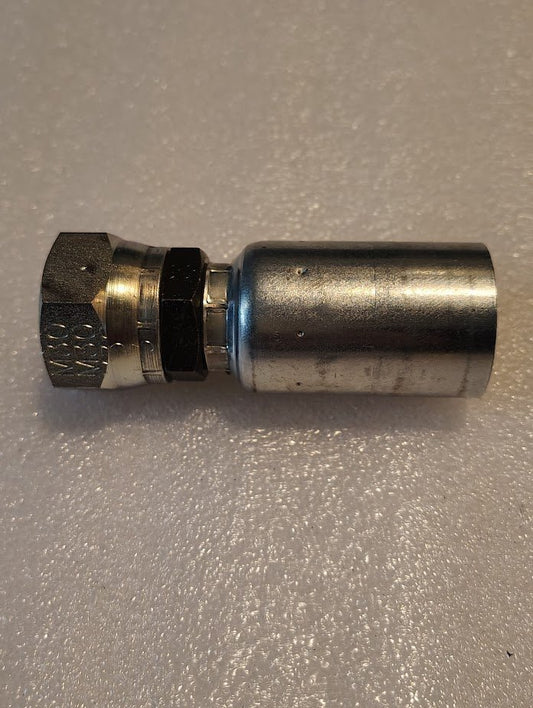 The 12U-30K Weatherhead fitting, a M30x1.5 Komatsu Female Straight Swivel with hexagonal nut and cylindrical body, sits on a textured white surface.