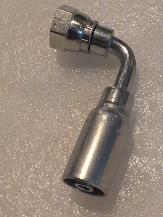 Close-up of the 06U-76P Weatherhead fitting: a 3/8 hose x 3/8 BSPP female fitting with a 90-degree swivel. Its cylindrical body and elbow joint shine against the textured, light background, highlighting its sleek design and compatibility with diverse systems.