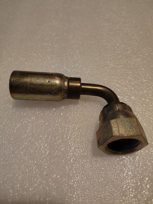 The 06U-78P Weatherhead fitting, featuring a 3/8 hose x 1/2 BSPP female swivel with a right-angle bend, is ideal for hydraulic hose links and displayed on a textured surface, ready for integration with 100R1 hoses.
