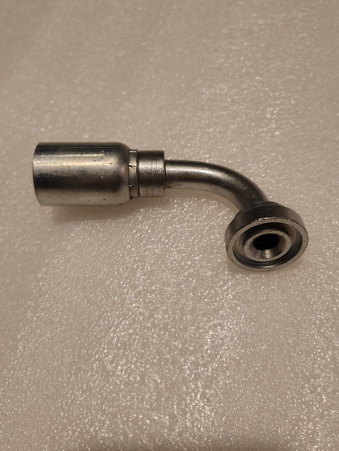 On a textured beige surface lies a metallic curved 08U-G71 Weatherhead fitting, 1/2 hose and flat Code 61 flange ends at 90 degrees, compatible with 100R1 hydraulic hoses for reliable connectivity.